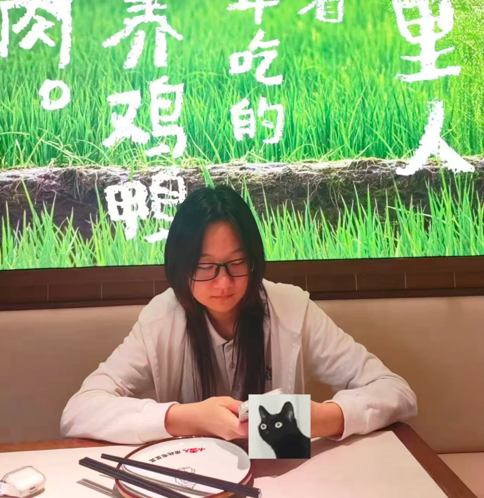 Ash Wang sitting at a table.