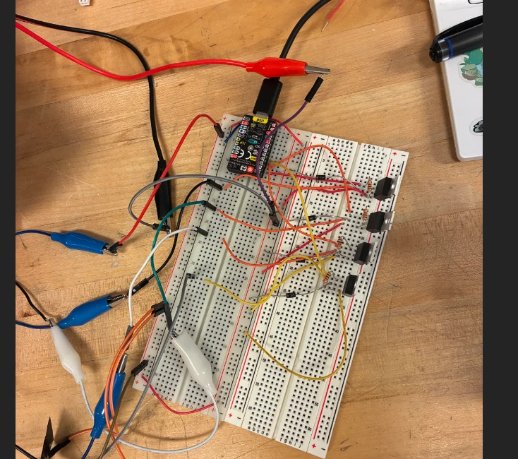 An ESP32 breadboard circuit with switches, resistors, and wires.